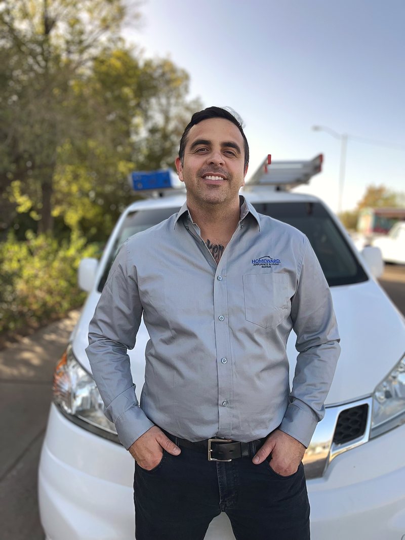 Owner of Homeward Repair standing in front of the company van